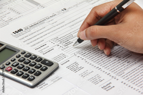 Person filing 1040 tax form © pkstock