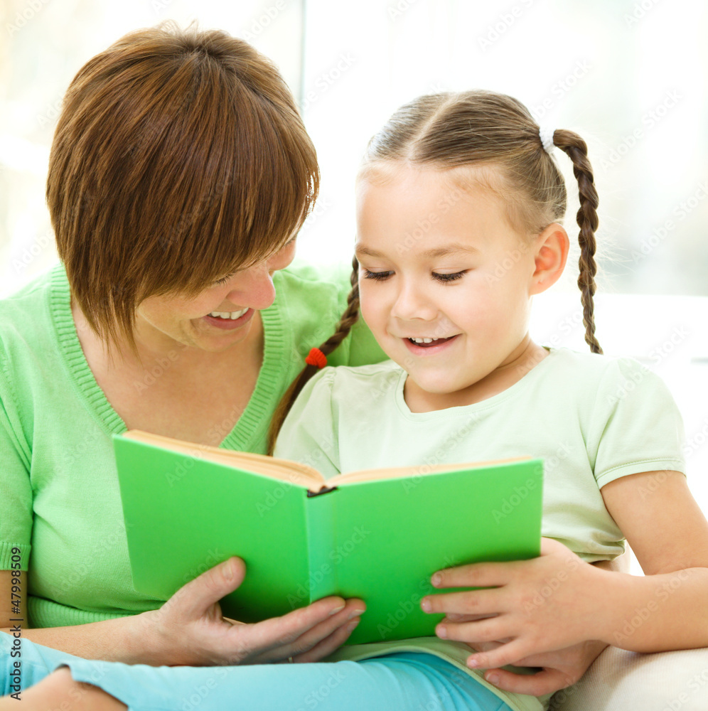 Mother is reading book with her daughter Mother is reading book with her daughter