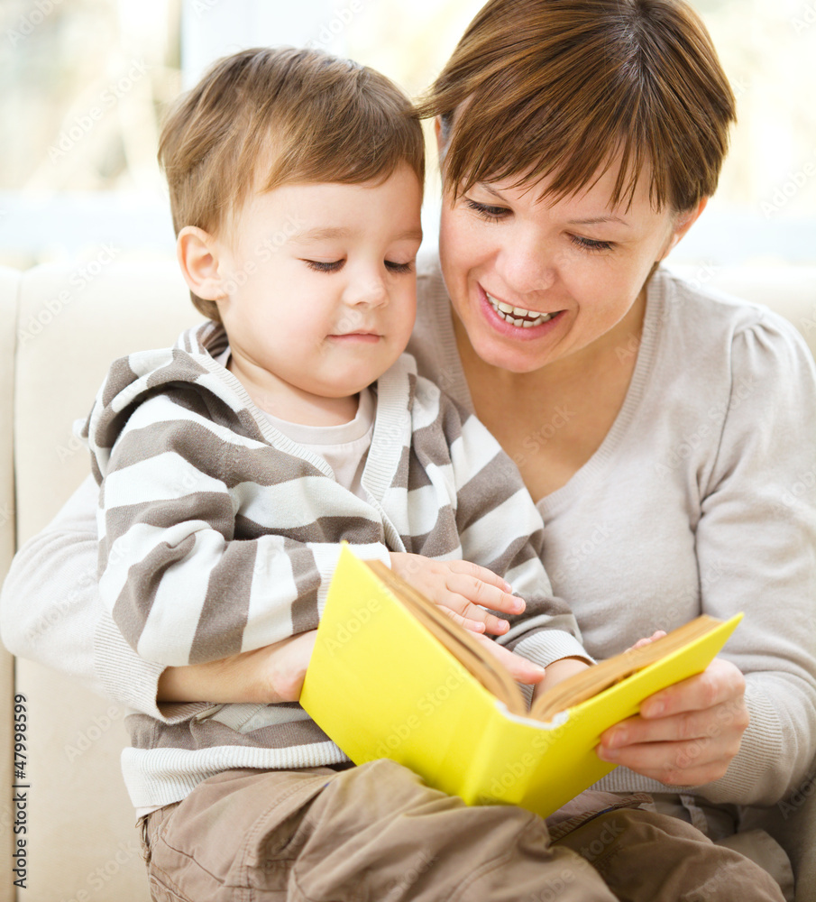 Mother is reading book for her son Mother is reading book for her son