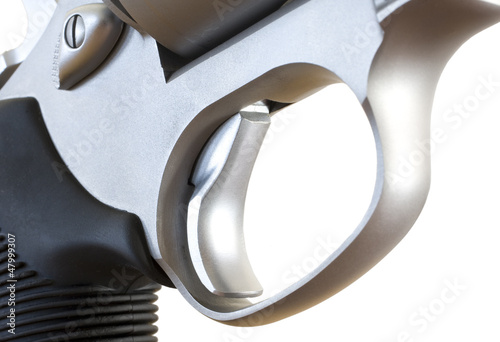 Triggerguard and trigger on a large steel revolver isolated on a white background photo