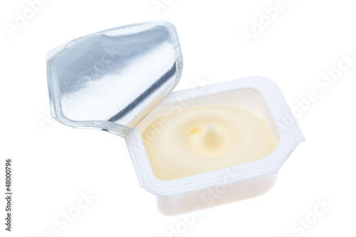 Open plastic packages of butter. On a white background.