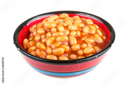 Marinated haricot beans in tomato sauce with shallots on a plate
