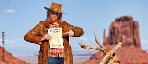 panoramic view of bad cowgirl with wanted paper