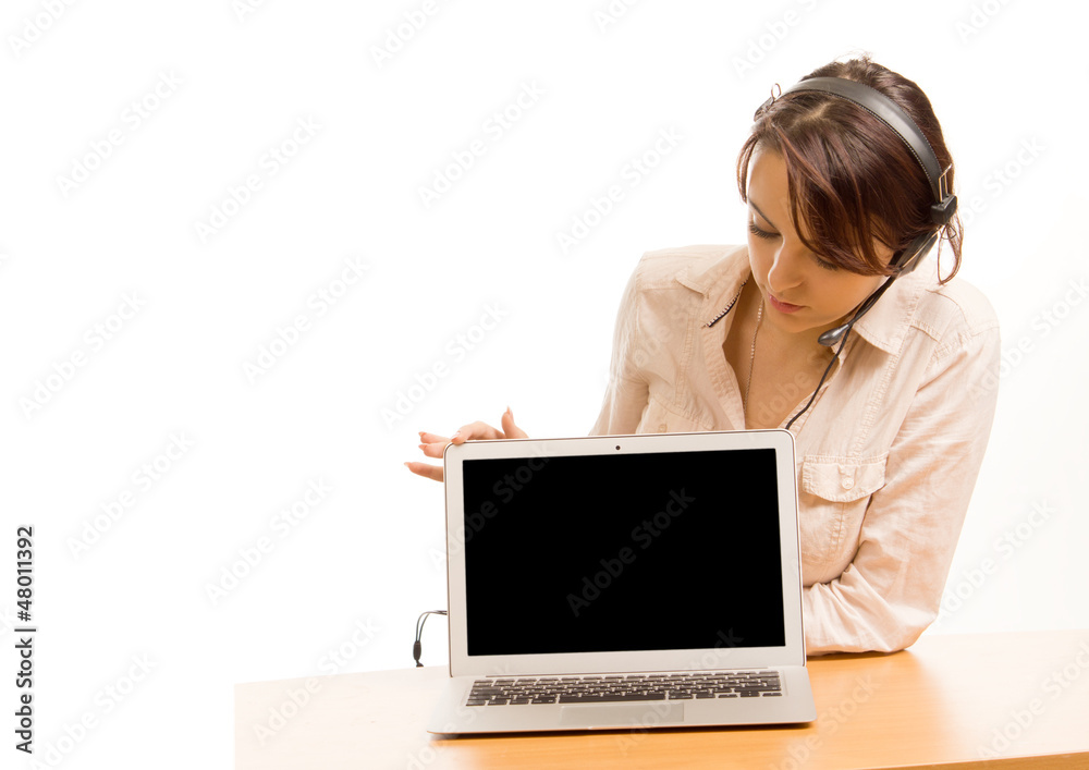 Woman wearing a headset looking at her laptop