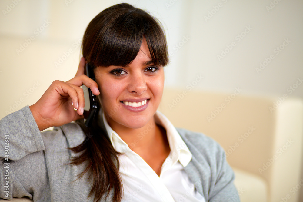Smiling young woman speaking on cellphone Smiling young woman speaking on cellphone