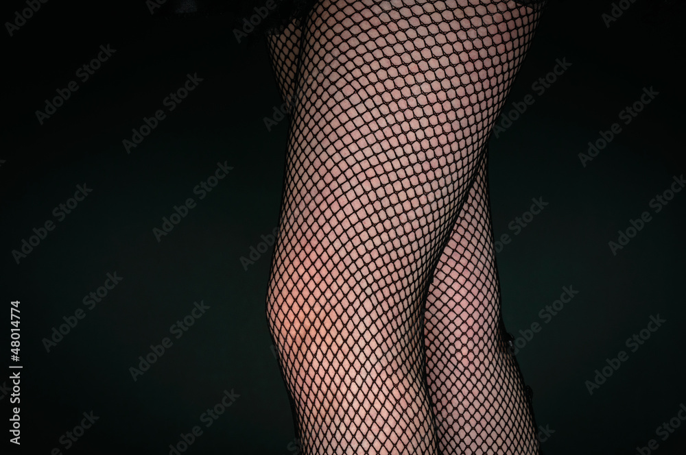 Legs of a youn woman against dark background Legs of a youn woman against dark background