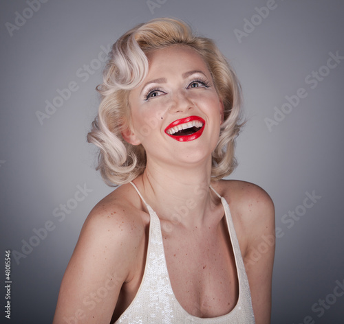 Pretty blond girl model like Marilyn Monroe in white dress