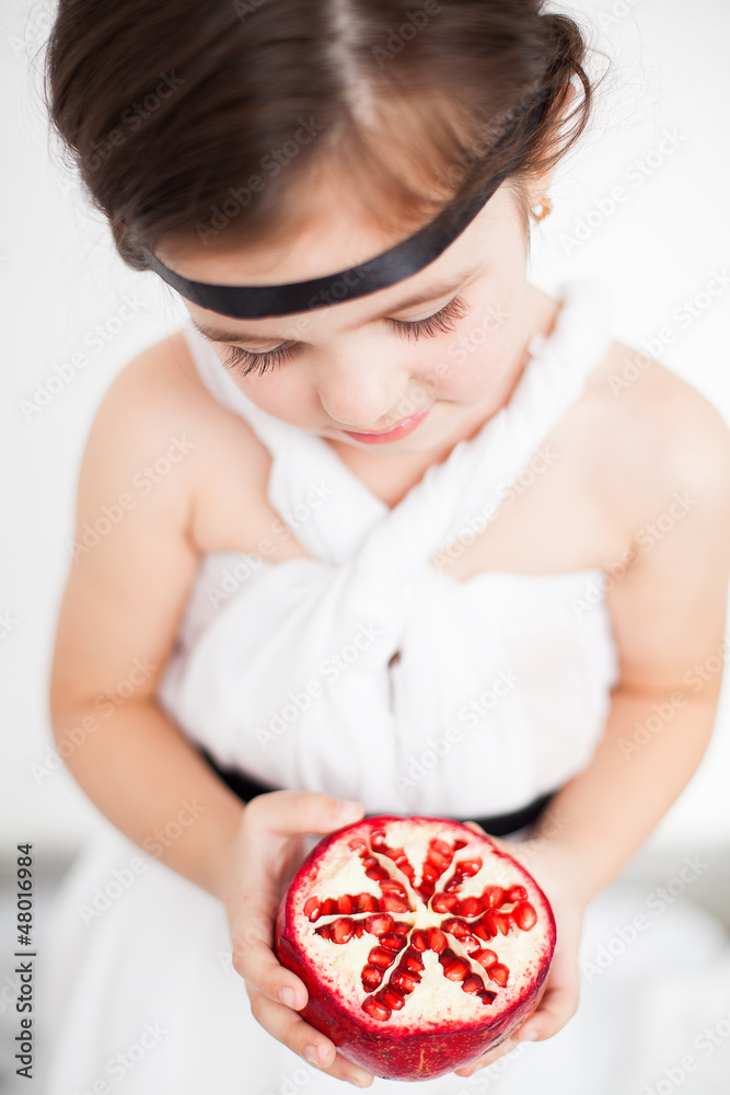 child model view in luxurious white dress with pomegranate child model view in luxurious white dress with pomegranate