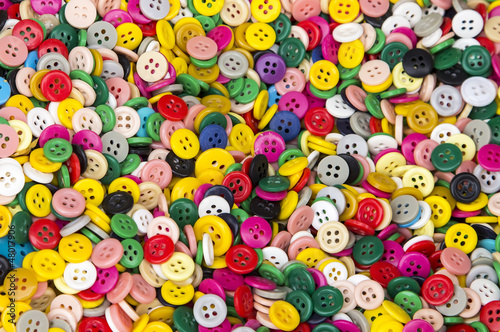 Background or texture of a pile of buttons of many colors and si
