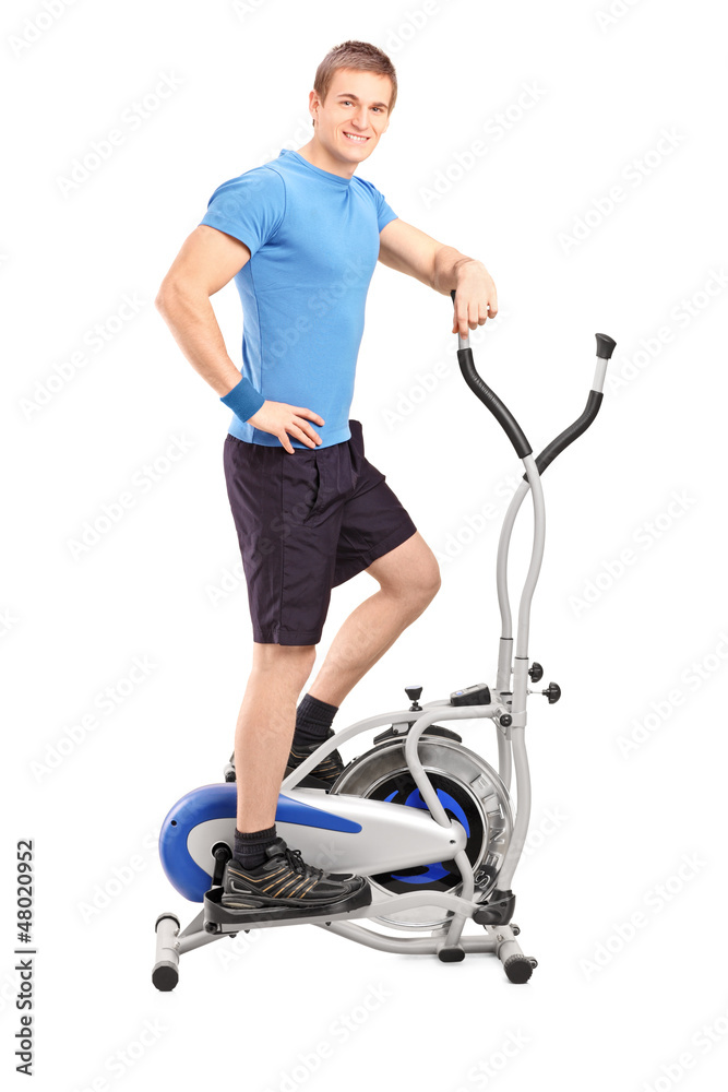 Athlete standing on a cross trainer machine Athlete standing on a cross trainer machine