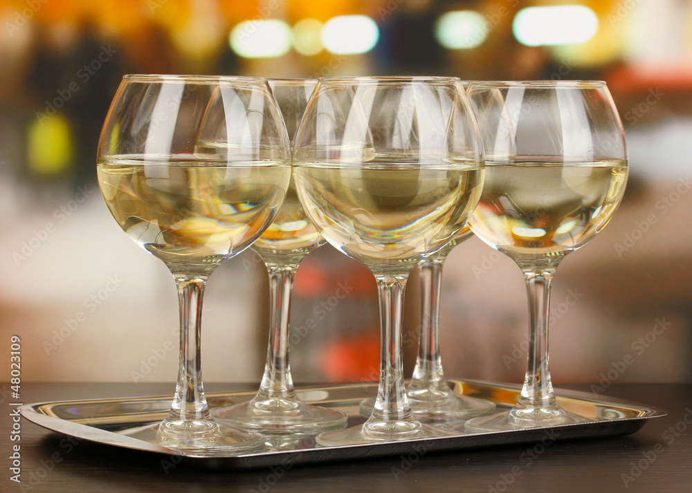 White wine in glass on room background White wine in glass on room background