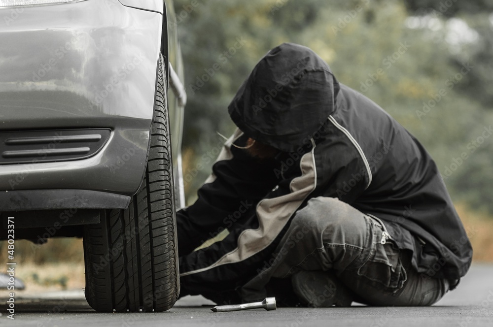 Young man repairing car outdoors Young man repairing car outdoors