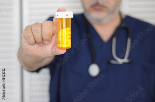 doctor with pill bottle