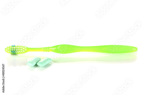 Toothbrush and chewing gum isolated on white