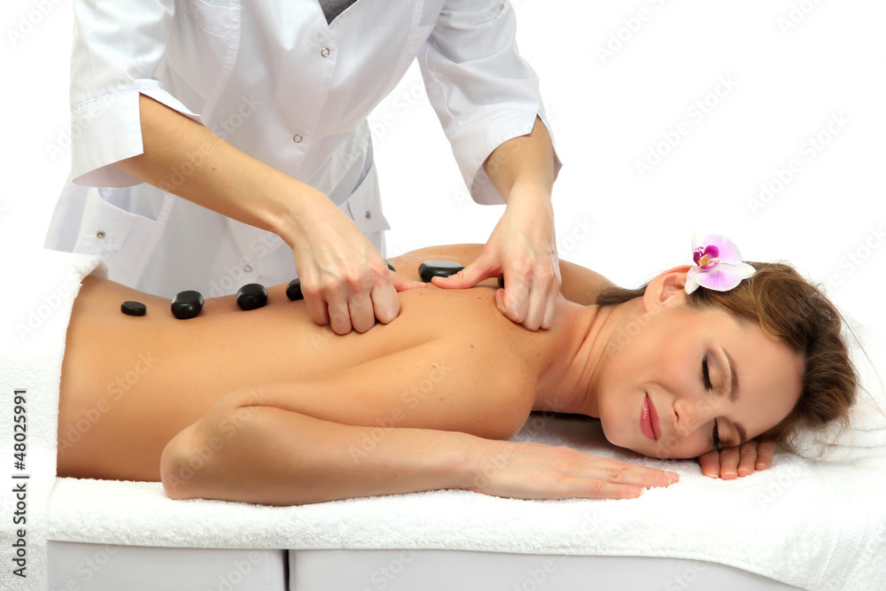 beautiful woman in spa salon with spa stones  getting massage,