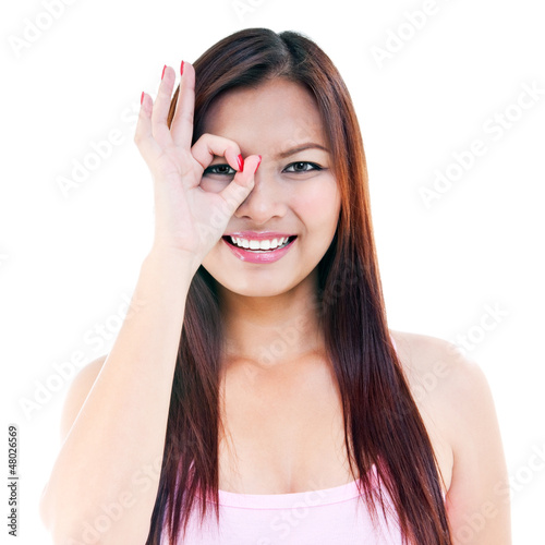Young Woman Giving OK gesture On Face