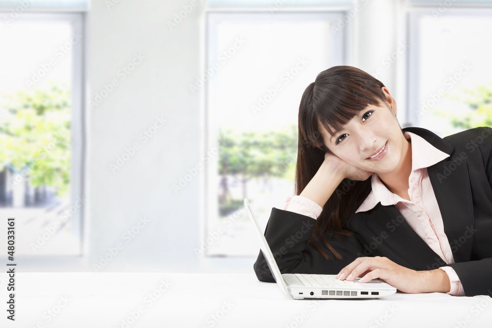smiling young businesswoman with laptop in the office smiling young businesswoman with laptop in the office