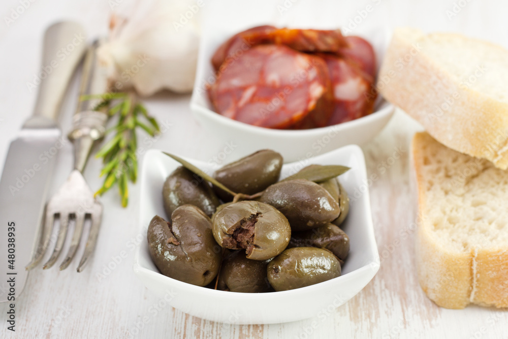 olives with chorizo in white bowls olives with chorizo in white bowls