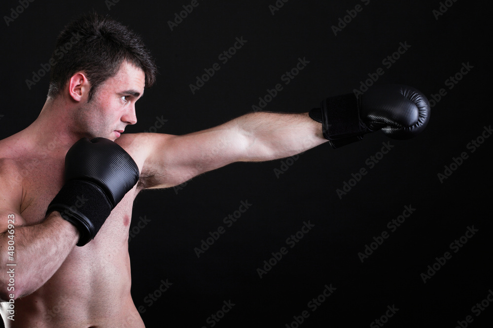 Portrait sportsman boxer in studio dark background Portrait sportsman boxer in studio dark background
