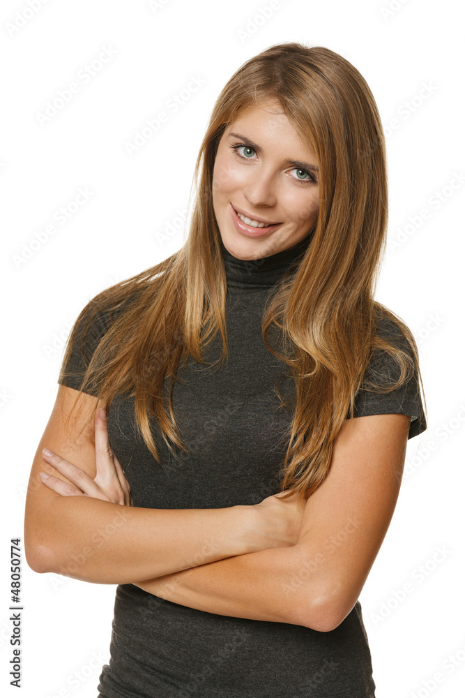 Portrait of beautiful young female standing with folded hands