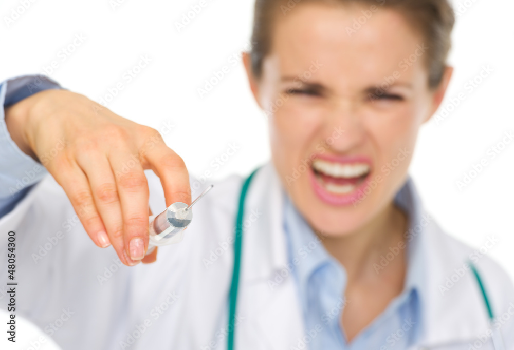 Closeup on syringe in hands of frightening medical doctor Closeup on syringe in hands of frightening medical doctor