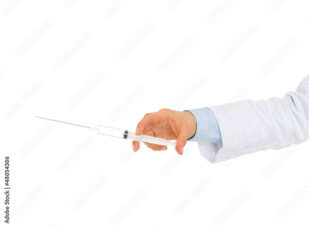 Closeup on hand of medical doctor holding syringe Closeup on hand of medical doctor holding syringe