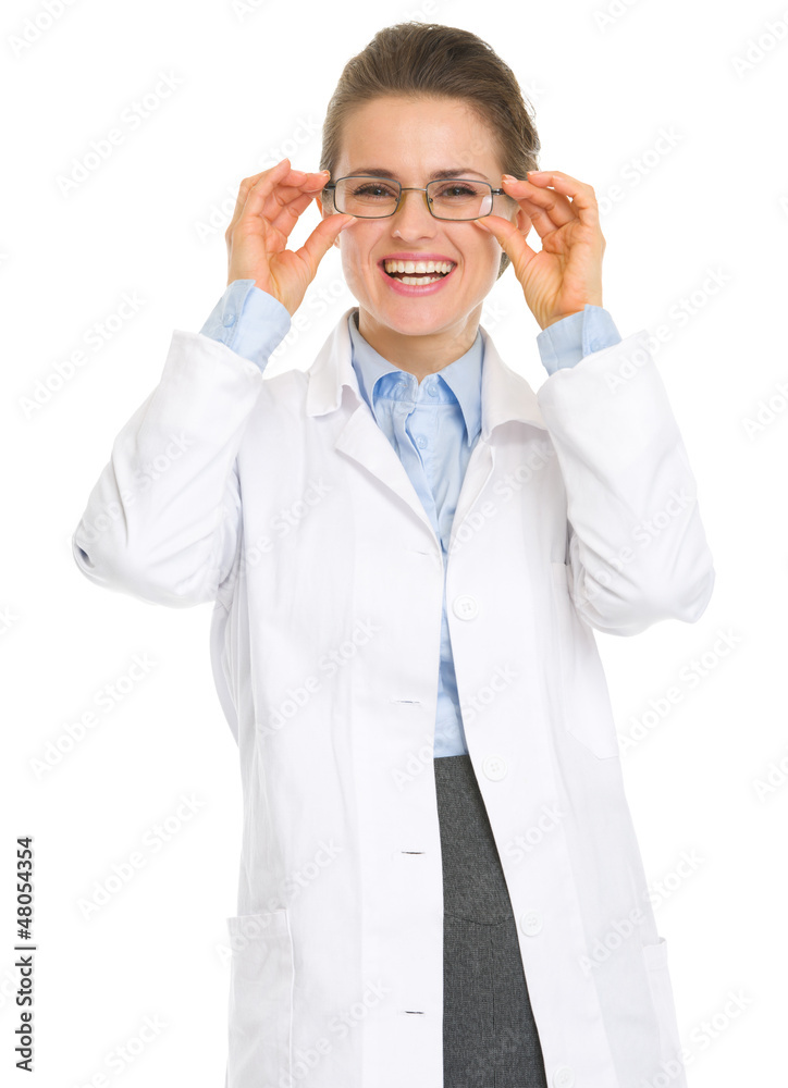 Smiling ophthalmologist doctor straitening glasses Smiling ophthalmologist doctor straitening glasses