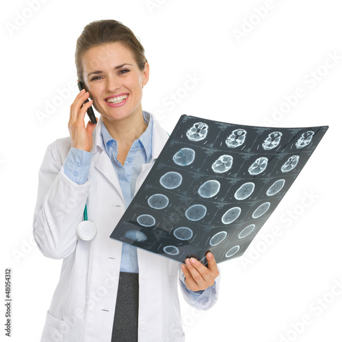 Smiling medical doctor woman speaking mobile and holding MRI photo