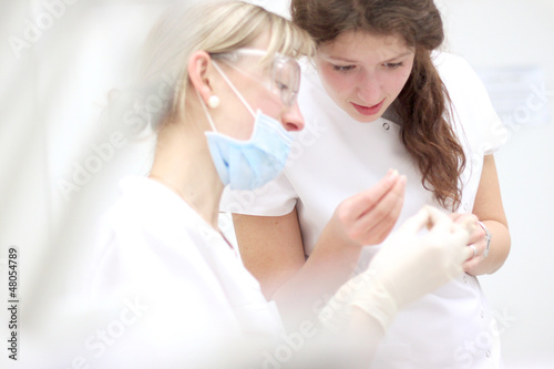 Dental students helping each other at practice