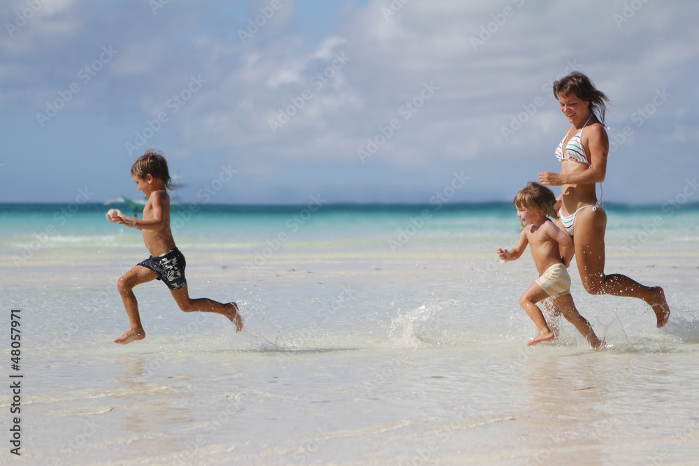 young happy family - mother and children - having fun on tropic young happy family - mother and children - having fun on tropic