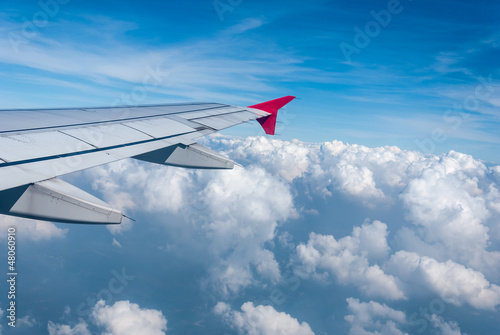 Wing of the plane on sky background - View of jet plane wing