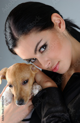 Portrait of sophisticated brunette woman with small dog