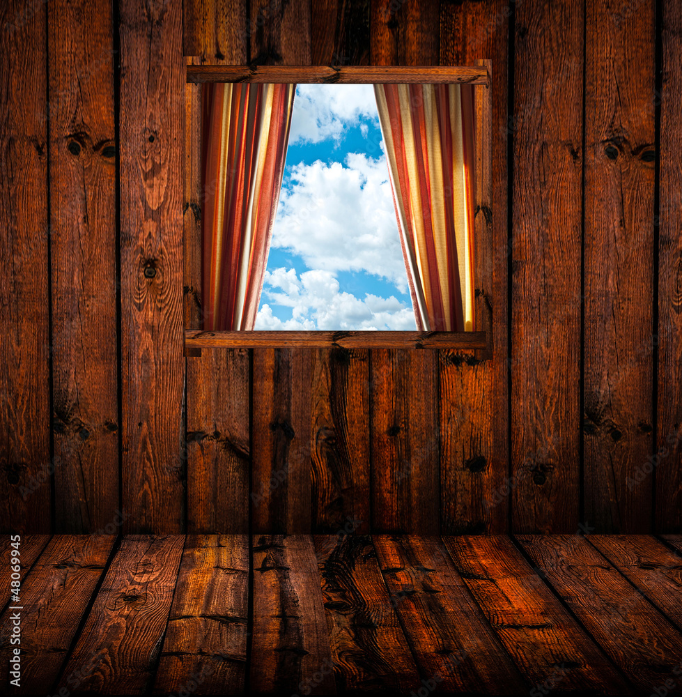 Skyscape through window of wooden cottage