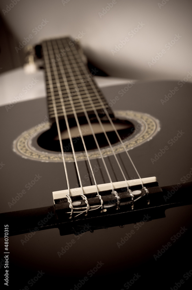 Fototapeta premium black acoustic guitar close up in sepia