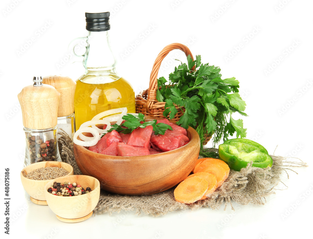 Raw beef meat in bowl with herbs, spices and cooking oil Raw beef meat in bowl with herbs, spices and cooking oil