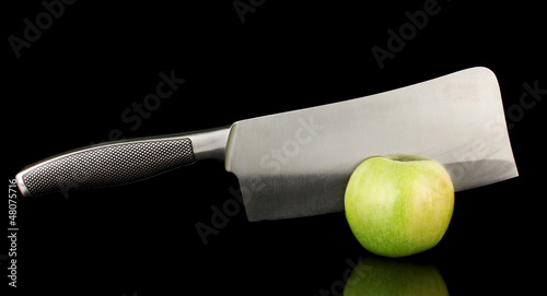 Green apple and knife isolated on black photo