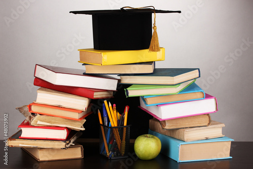 Books and magister cap against school board photo