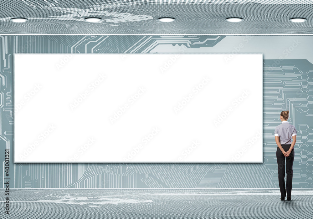 Business person standing near a blank billboard Business person standing near a blank billboard