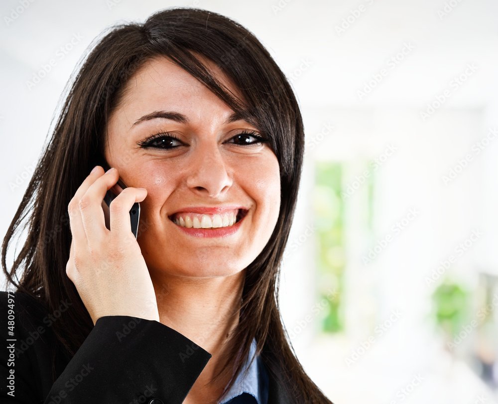 Smiling businesswoman talking on the phone Smiling businesswoman talking on the phone
