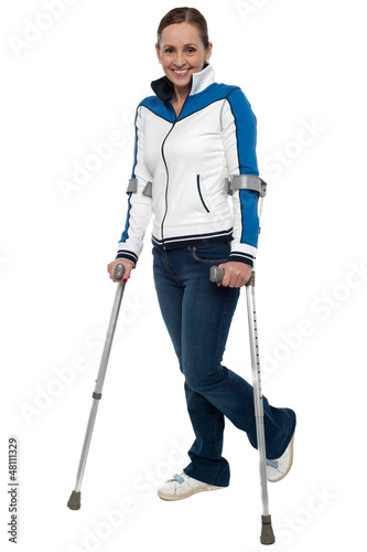 Tablou canvas Woman walking with the support of crutches