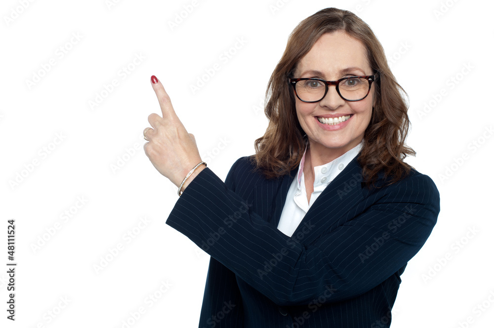 Beautiful executive in suit gesturing copy space Beautiful executive in suit gesturing copy space