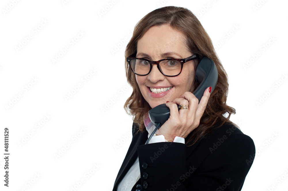 Bespectacled woman talking over the phone Bespectacled woman talking over the phone