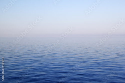 Blue sea with waves and clear blue sky © PriceM
