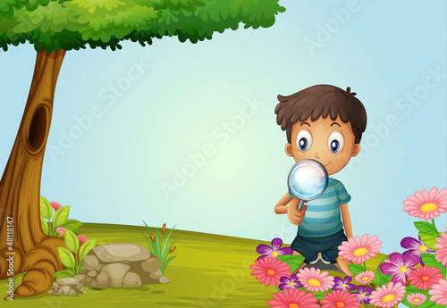 A boy with lense in garden