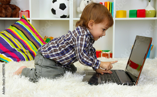 cute little boy and noteboo...