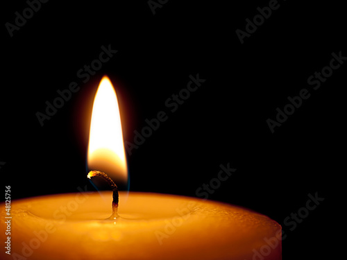 Single candle close - black background