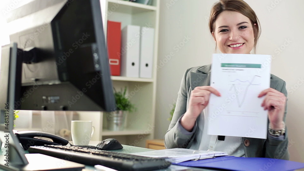 Young businesswoman showing document and thumb up sign Young businesswoman showing document and thumb up sign