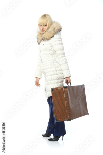 portrait of blonde girl in warm jacket with suitcase