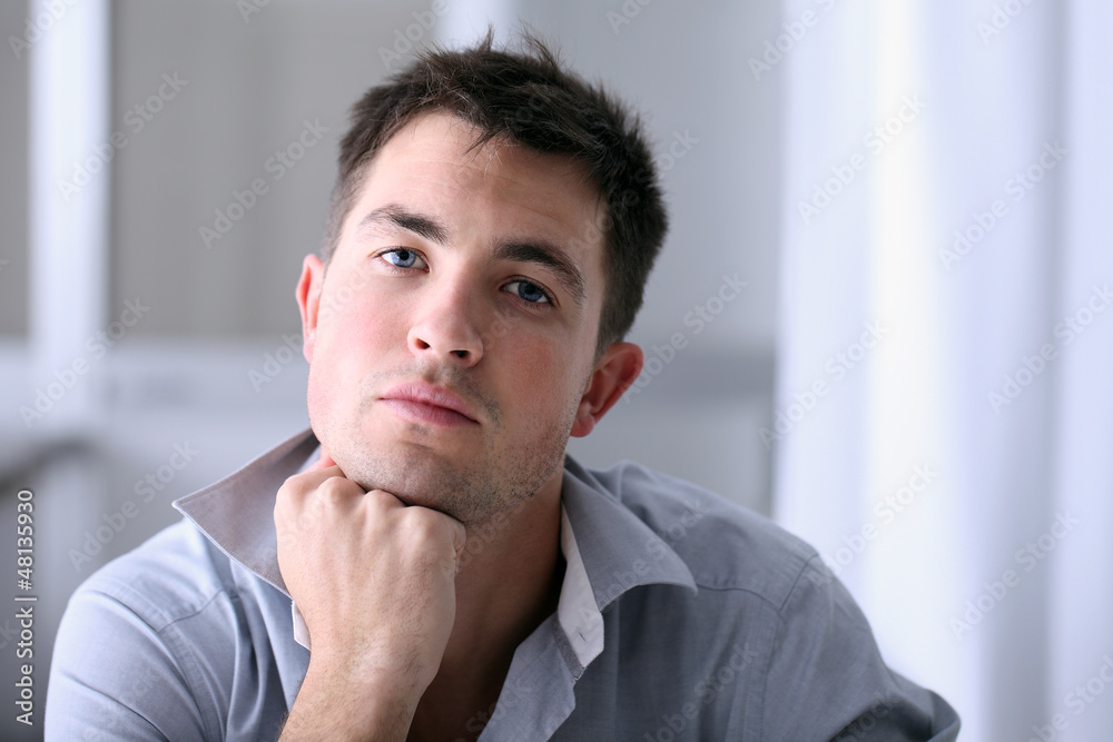 Man in home office with thoughtful look Man in home office with thoughtful look