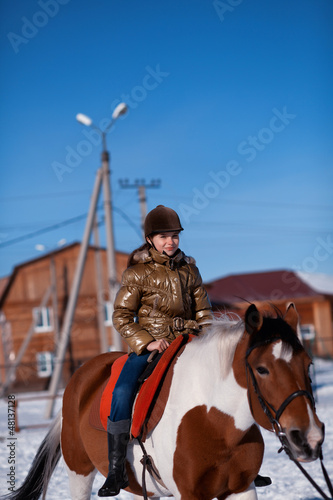 Happy girl riding horse